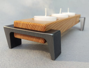 Light toned wooden tea light candle tray, 3 candle capacity, with dark metal angled legs on each end