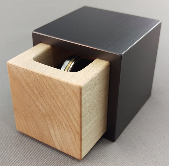 Modern Cube shaped ring box with gun metal grey exterior, and white maple insert