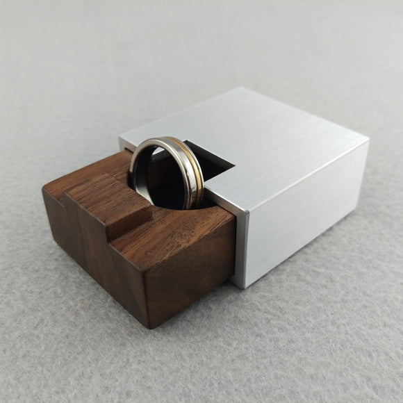 Silver metal rectangular engagement ring box with brown walnut insert that slides inside