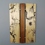 Wood Wall art with three vertical panels. Electrical arc patterns burnt into outer panels, center section is orange brown wood
