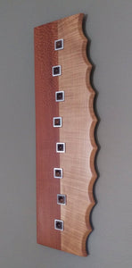 wood and metal wall art, light maple and darker lacewood, silver square metal inlays filled with black walnut