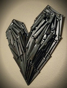 3D Metal heart sculpture, made from layers of welded black nails