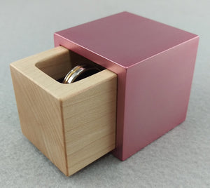 Cube metal and wood engagement ring box, pink outer shell with sliding white maple insert
