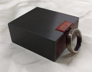 Slim engagement ring box, dark gunmetal grey, with red bloodwood wooden interior. 