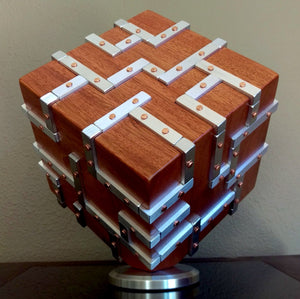 Wooden Cube sculpture with grid of silver aluminum inlays that are fastened onto wood with copper nails