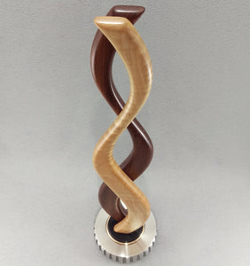 small tabletop sculpture with red and white wood, silver metal base with bronze and black inlays