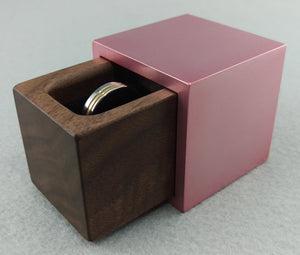 Modern cube shaped pink engagement ring box with black walnut wood insert