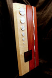 rectangular wood and metal wall art. white maple and red padauk, with various geometric polished aluminum details.